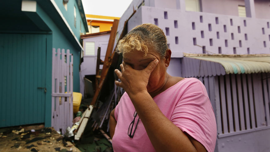 A Hurricane Maria survivor weeps amid the storm's destruction.